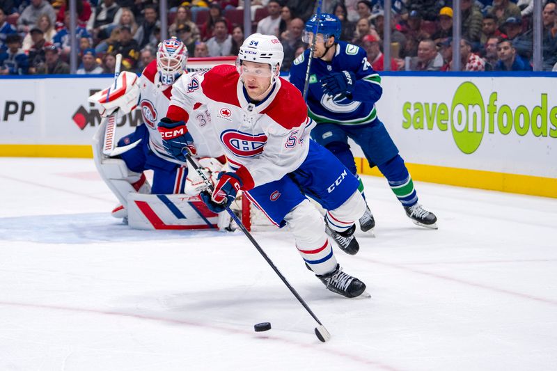 Mar 21, 2024; Vancouver, British Columbia, CAN; Montreal Canadiens defenseman Jordan Harris (54) handles the puck against the Vancouver Canucks in the third period at Rogers Arena. Vancouver won 4 -1. Mandatory Credit: Bob Frid-USA TODAY Sports