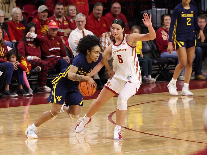 Jan 11, 2026; Ames, Iowa, USA; Iowa State Cyclones guard Evangelia Paulk (5) defends West Virginia Mountaineers guard Sydney Shaw (5) during the second half at James H. Hilton Coliseum. Mandatory Credit: Reese Strickland-Imagn Images