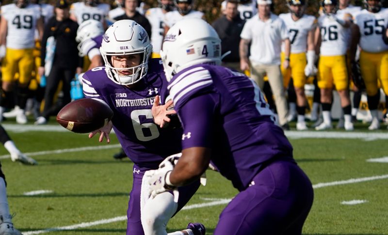 Nov 4, 2023; Chicago, Illinois, USA; Northwestern Wildcats quarterback Brendan Sullivan (6) pitches the ball against the Iowa Hawkeyes  during the first half at Wrigley Field. Mandatory Credit: David Banks-USA TODAY Sports