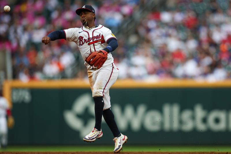Sep 30, 2024; Atlanta, Georgia, USA; Atlanta Braves second baseman Ozzie Albies (1) throws a runner out at first against the New York Mets in the third inning at Truist Park. Mandatory Credit: Brett Davis-Imagn Images
