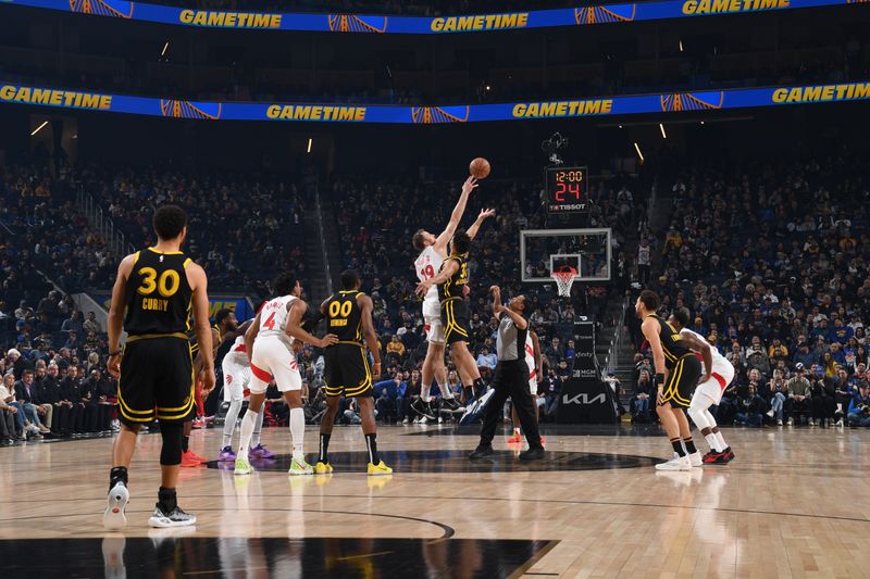 SAN FRANCISCO, CA - JANUARY 7: Jakob Poeltl #19 of the Toronto Raptors and Trayce Jackson-Davis #32 of the Golden State Warriors  go up for a jump ball during the game on January 7, 2024 at Chase Center in San Francisco, California. NOTE TO USER: User expressly acknowledges and agrees that, by downloading and or using this photograph, user is consenting to the terms and conditions of Getty Images License Agreement. Mandatory Copyright Notice: Copyright 2024 NBAE (Photo by Noah Graham/NBAE via Getty Images)