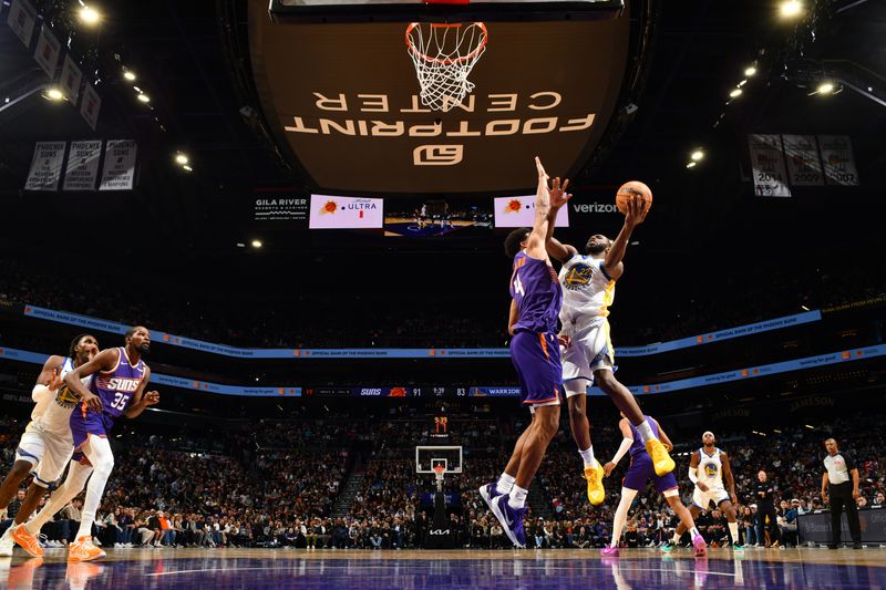 PHOENIX, AZ - NOVEMBER 30: Andrew Wiggins #22 of the Golden State Warriors drives to the basket during the game against the Phoenix Suns on November 30, 2024 at Footprint Center in Phoenix, Arizona. NOTE TO USER: User expressly acknowledges and agrees that, by downloading and or using this photograph, user is consenting to the terms and conditions of the Getty Images License Agreement. Mandatory Copyright Notice: Copyright 2024 NBAE (Photo by Barry Gossage/NBAE via Getty Images)