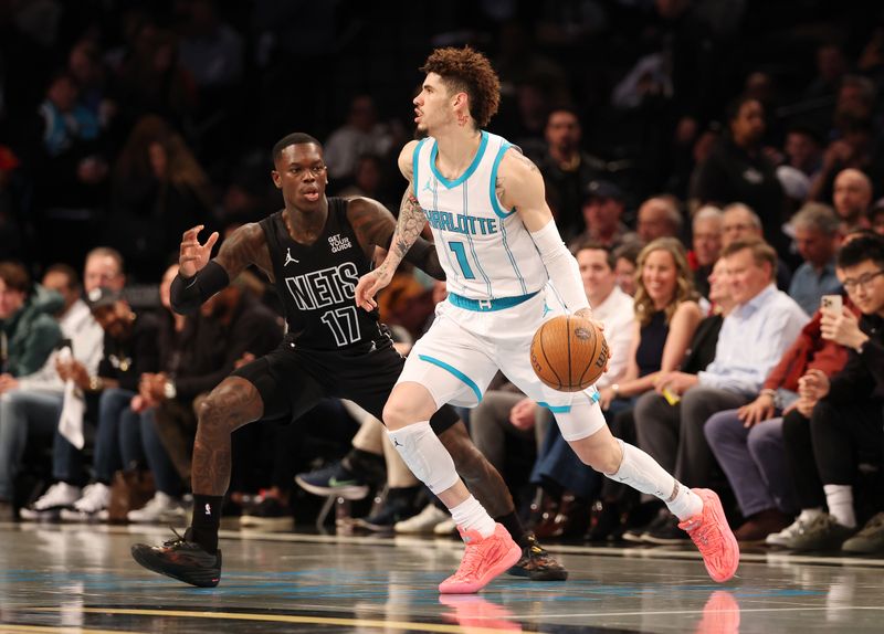 NEW YORK, NEW YORK - NOVEMBER 19:  LaMelo Ball #1 of the Charlotte Hornets drives against Dennis Schroder #17 of the Brooklyn Nets during their game at Barclays Center on November 19, 2024 in New York City.   User expressly acknowledges and agrees that, by downloading and or using this photograph, User is consenting to the terms and conditions of the Getty Images License Agreement.  (Photo by Al Bello/Getty Images)