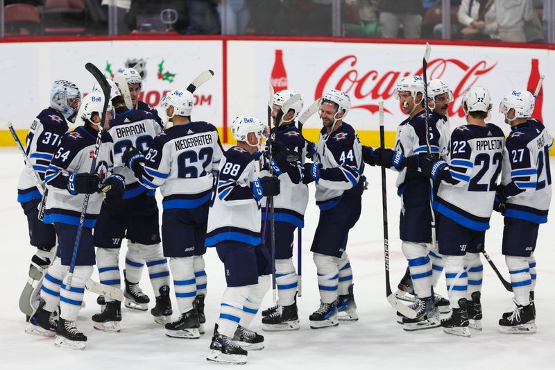 Nov 24, 2023; Sunrise, Florida, USA; Winnipeg Jets players celebrate after winning the game against the Florida Panthers at Amerant Bank Arena. Mandatory Credit: Sam Navarro-USA TODAY Sports