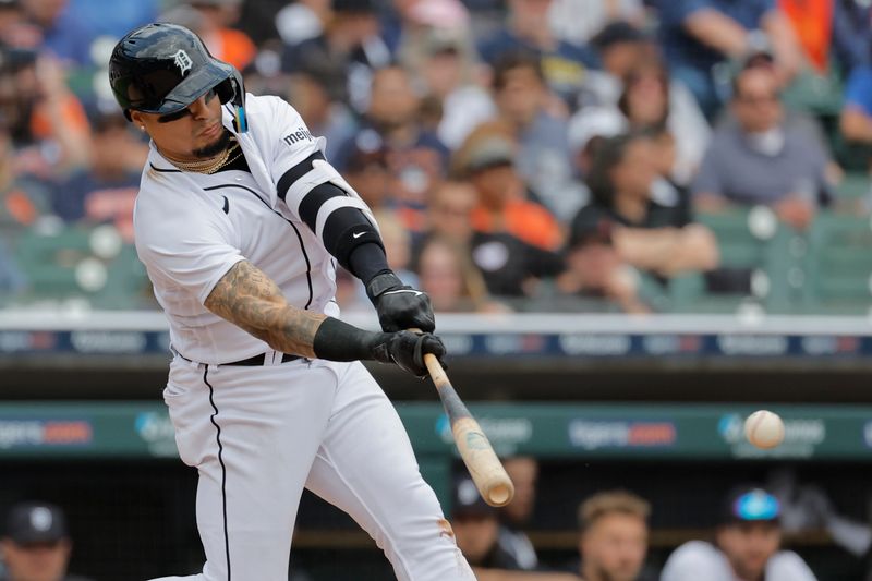 Jun 14, 2023; Detroit, Michigan, USA;  Detroit Tigers shortstop Javier Baez (28) hits a single in the sixth inning against the Atlanta Braves at Comerica Park. Mandatory Credit: Rick Osentoski-USA TODAY Sports