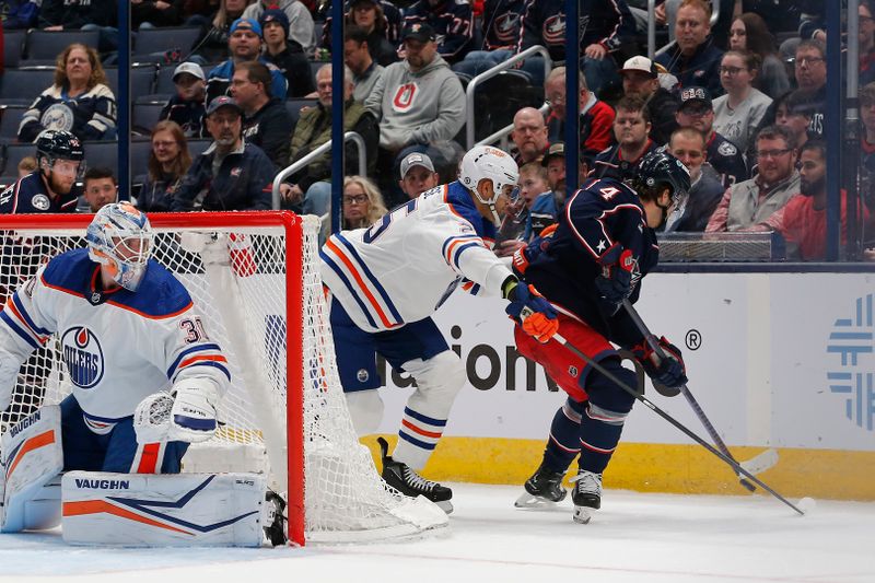 Mar 7, 2024; Columbus, Ohio, USA; Columbus Blue Jackets Forward Cole Sillinger (4) and Edmonton Oilers defenseman Darnell Nurse (25) battle a the puck during the first period at Nationwide Arena. Mandatory Credit: Russell LaBounty-USA TODAY Sports