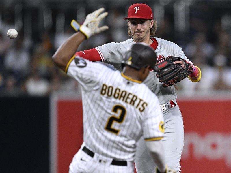 Sep 5, 2023; San Diego, California, USA; Philadelphia Phillies second baseman Bryson Stott (5) throws to first base after forcing out San Diego Padres shortstop Xander Bogaerts (2) at second base to complete a double play during the third inning at Petco Park. Mandatory Credit: Orlando Ramirez-USA TODAY Sports