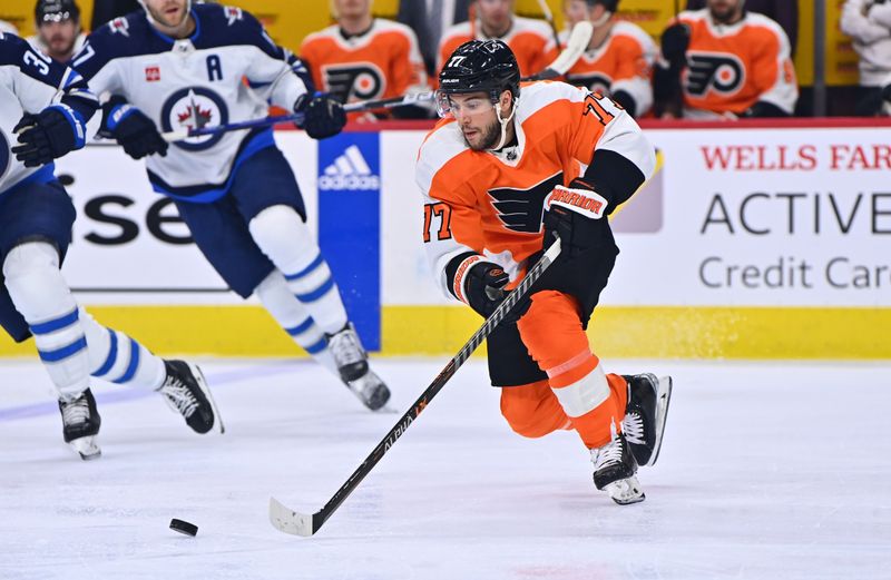 Jan 22, 2023; Philadelphia, Pennsylvania, USA; Philadelphia Flyers defenseman Tony DeAngelo (77) reaches for the puck against the Winnipeg Jets in the first period at Wells Fargo Center. Mandatory Credit: Kyle Ross-USA TODAY Sports