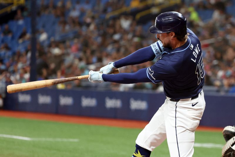 Jun 24, 2024; St. Petersburg, Florida, USA; Tampa Bay Rays outfielder Josh Lowe (15) singles against the Seattle Mariners during the third inning at Tropicana Field. Mandatory Credit: Kim Klement Neitzel-USA TODAY Sports