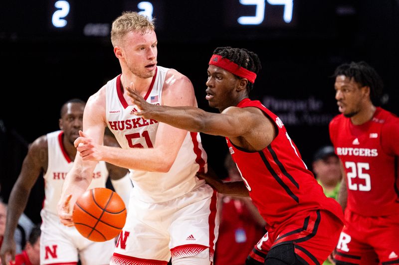 Mar 3, 2024; Lincoln, Nebraska, USA; Nebraska Cornhuskers forward Rienk Mast (51) passes against Rutgers Scarlet Knights forward Antwone Woolfolk (13) during the second half at Pinnacle Bank Arena. Mandatory Credit: Dylan Widger-USA TODAY Sports