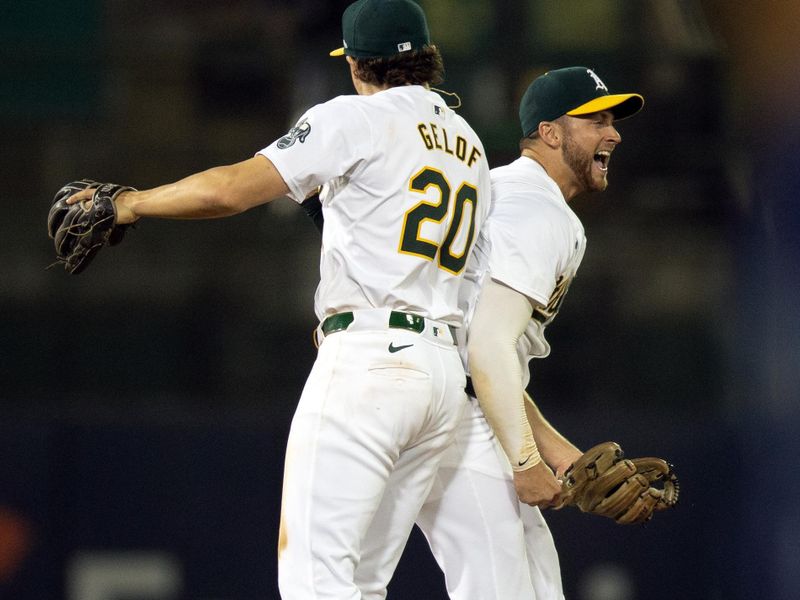 Jun 5, 2024; Oakland, California, USA; Oakland Athletics second baseman Zack Gelof (20) and shortstop Max Schuemann (12) celebrate their game-ending double play against the Seattle Mariners during the ninth inning at Oakland-Alameda County Coliseum. Mandatory Credit: D. Ross Cameron-USA TODAY Sports