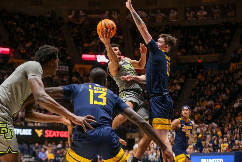 Feb 17, 2024; Morgantown, West Virginia, USA; Baylor Bears guard RayJ Dennis (10) shoots in the lane against West Virginia Mountaineers forward Quinn Slazinski (11) during the first half at WVU Coliseum. Mandatory Credit: Ben Queen-USA TODAY Sports