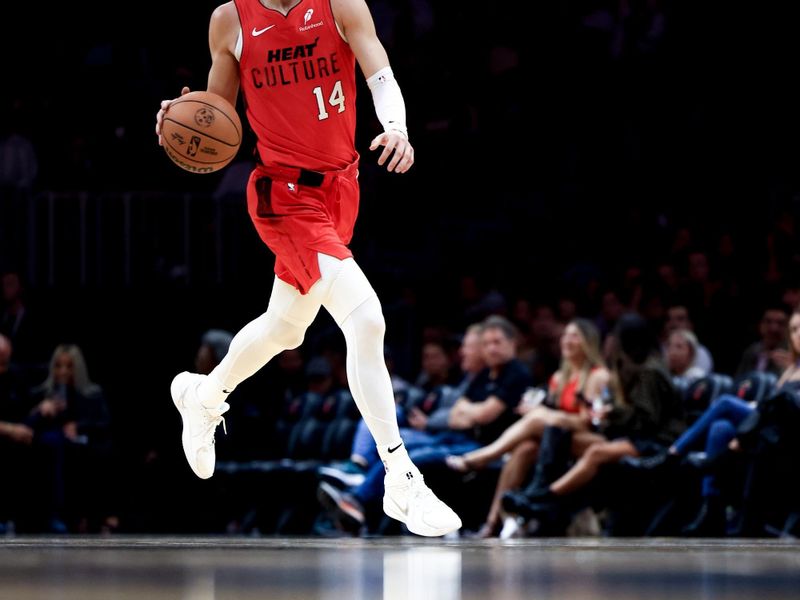 MIAMI, FLORIDA - NOVEMBER 18: Tyler Herro #14 of the Miami Heat brings the ball up court against the Philadelphia 76ers during the second half at Kaseya Center on November 18, 2024 in Miami, Florida. NOTE TO USER: User expressly acknowledges and agrees that, by downloading and or using this Photograph, user is consenting to the terms and conditions of the Getty Images License Agreement.  (Photo by Carmen Mandato/Getty Images)