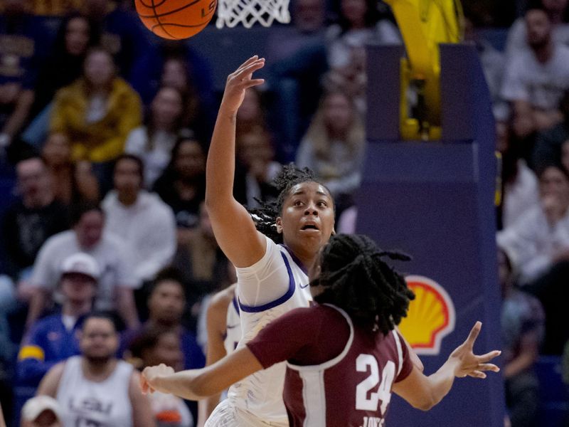 Jan 11, 2024; Baton Rouge, Louisiana, USA; LSU Lady Tigers guard Mikaylah Williams steals the ball from Texas A&M Aggies guard Sahara Jones (24) during the second half at Pete Maravich Assembly Center. Mandatory Credit: Matthew Hinton-USA TODAY Sports