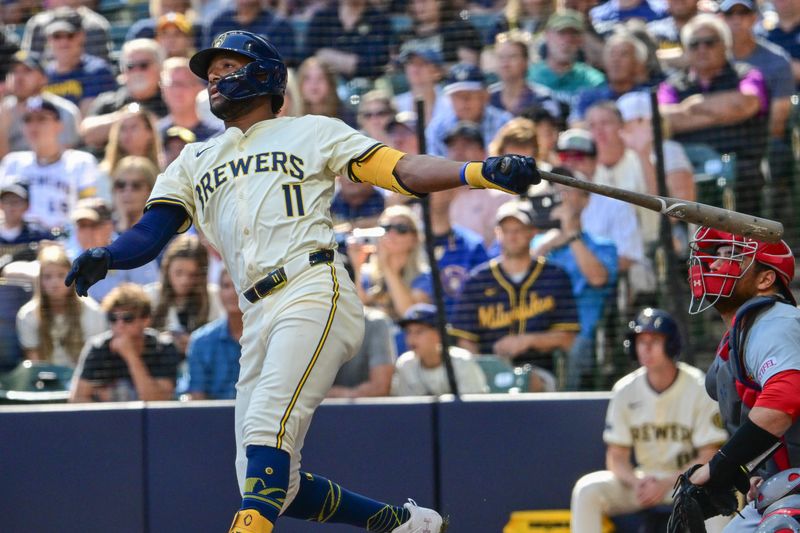 Sep 2, 2024; Milwaukee, Wisconsin, USA; Milwaukee Brewers left fielder Jackson Chourio (11) hits a grand slam home run in the sixth inning as St. Louis Cardinals catcher Pedro Pages (43) looks on at American Family Field. Mandatory Credit: Benny Sieu-USA TODAY Sports