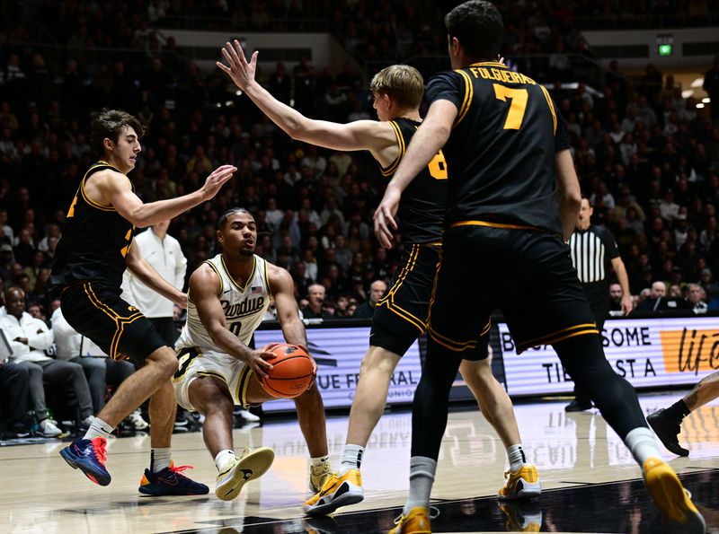 Jan 14, 2026; West Lafayette, Indiana, USA; Purdue Boilermakers guard C.J Cox (0) fakes out multiple Iowa Hawkeyes during the second half at Mackey Arena. Mandatory Credit: Marc Lebryk-Imagn Images