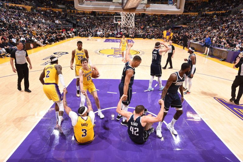 LOS ANGELES, CA - JANUARY 17:  Jarred Vanderbilt #2 of the Los Angeles Lakers & Austin Reaves #15 of the Los Angeles Lakers, Grant Williams #3 of the Dallas Mavericks & Tim Hardaway Jr. #10 of the Dallas Mavericks help respective teammates up during the game Anthony Davis #3 of the Los Angeles Lakers & Maxi Kleber #42 of the Dallas Mavericks on January 17, 2024 at Crypto.Com Arena in Los Angeles, California. NOTE TO USER: User expressly acknowledges and agrees that, by downloading and/or using this Photograph, user is consenting to the terms and conditions of the Getty Images License Agreement. Mandatory Copyright Notice: Copyright 2024 NBAE (Photo by Andrew D. Bernstein/NBAE via Getty Images)