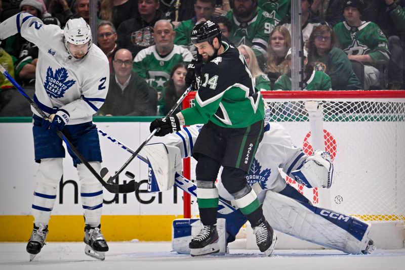 Dec 21, 2025; Dallas, Texas, USA; Dallas Stars left wing Jamie Benn (14) redirects the puck past Toronto Maple Leafs defenseman Simon Benoit (2) and goaltender Dennis Hildeby (35) for a goal during the third period at the American Airlines Center. Mandatory Credit: Jerome Miron-Imagn Images