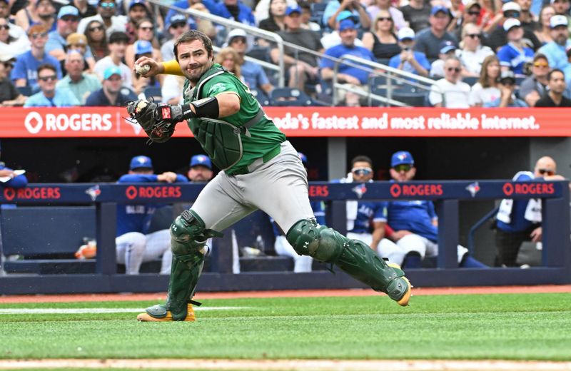 Aug 10, 2024; Toronto, Ontario, CAN; Oakland Athletics catcher Shea Langeliers (23) throws to first base in the fourth inning against the Toronto Blue Jays at Rogers Centre. Mandatory Credit: Gerry Angus-USA TODAY Sports