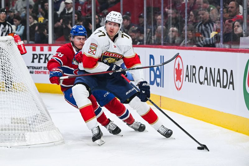 Mar 15, 2025; Montreal, Quebec, CAN; Florida Panthers defenseman Niko Mikkola (77) defends the puck against Montreal Canadiens center Christian Dvorak (28) in the first period at Bell Centre. Mandatory Credit: David Kirouac-Imagn Images