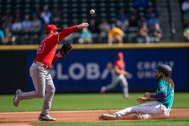 Sep 13, 2023; Seattle, Washington, USA; Los Angeles Angels second baseman Brandon Drury (23) attempts to turn a double play after forcing out Seattle Mariners shortstop J.P. Crawford (3) at second base during the first inning at T-Mobile Park. Mandatory Credit: Stephen Brashear-USA TODAY Sports