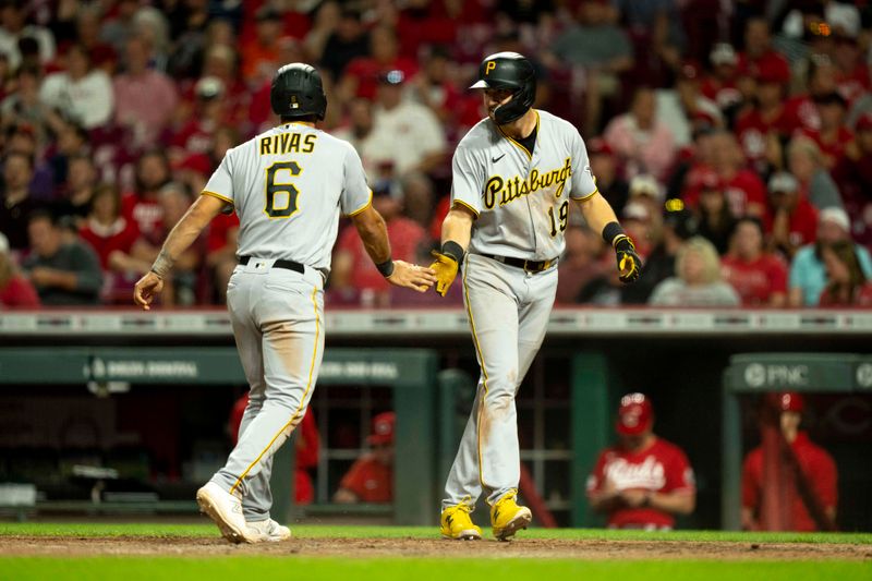 Sep 23, 2023; Cincinnati, Ohio, USA;  Pittsburgh Pirates first baseman Alfonso Rivas (6) greets third baseman Jared Triolo (19) after scoring in the eighth inning against the Cincinnati Reds at Great American Ball Park. Mandatory Credit: The Cincinnati Enquirer-USA TODAY Sports