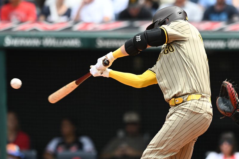 Jul 21, 2024; Cleveland, Ohio, USA; San Diego Padres catcher Kyle Higashioka (20) hits an RBI double during the second inning against the Cleveland Guardians at Progressive Field. Mandatory Credit: Ken Blaze-USA TODAY Sports