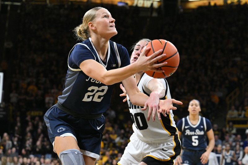 Feb 8, 2024; Iowa City, Iowa, USA; Penn State Nittany Lions guard Alli Campbell (22) goes to the basket as Iowa Hawkeyes guard Kate Martin (20) defends during the first half at Carver-Hawkeye Arena. Mandatory Credit: Jeffrey Becker-USA TODAY Sports