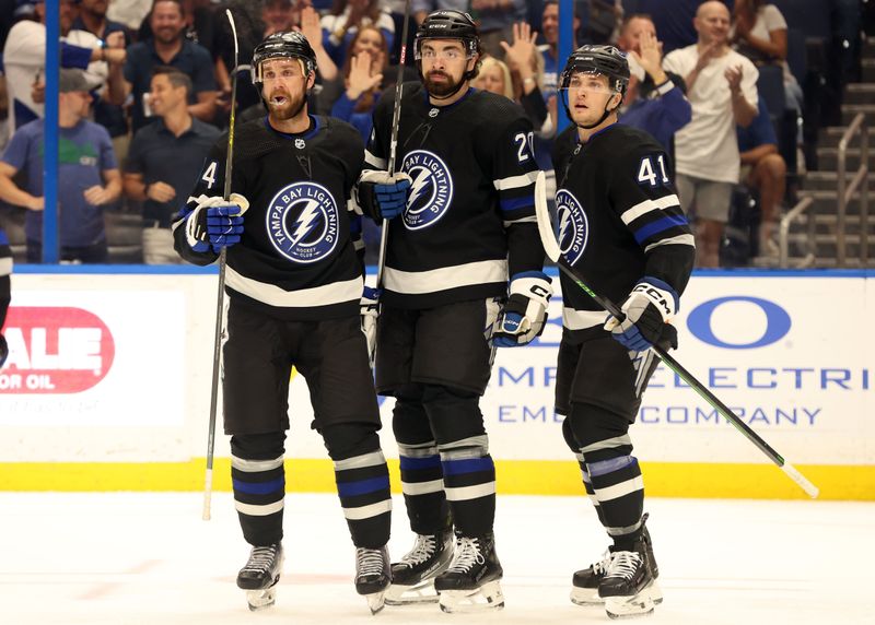 Apr 17, 2024; Tampa, Florida, USA; Tampa Bay Lightning left wing Nicholas Paul (20) is congratulated by defenseman Calvin de Haan (44) and right wing Mitchell Chaffee (41) after scoring against the Toronto Maple Leafs during the first period at Amalie Arena. Mandatory Credit: Kim Klement Neitzel-USA TODAY Sports