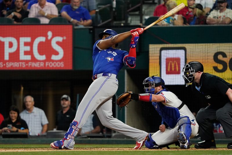 Sep 19, 2024; Arlington, Texas, USA; Toronto Blue Jays first baseman Vladimir Guerrero Jr. (27) hits a solo home run during the ninth inning against the Texas Rangers at Globe Life Field. Mandatory Credit: Raymond Carlin III-Imagn Images