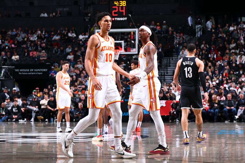BROOKLYN, NY - MARCH 16: Zaccharie Risacher #10 high fives Terance Mann #14 of the Atlanta Hawks during the game against the Brooklyn Nets on March 16, 2025 at Barclays Center in Brooklyn, New York. NOTE TO USER: User expressly acknowledges and agrees that, by downloading and or using this Photograph, user is consenting to the terms and conditions of the Getty Images License Agreement. Mandatory Copyright Notice: Copyright 2025 NBAE (Photo by David L. Nemec/NBAE via Getty Images)