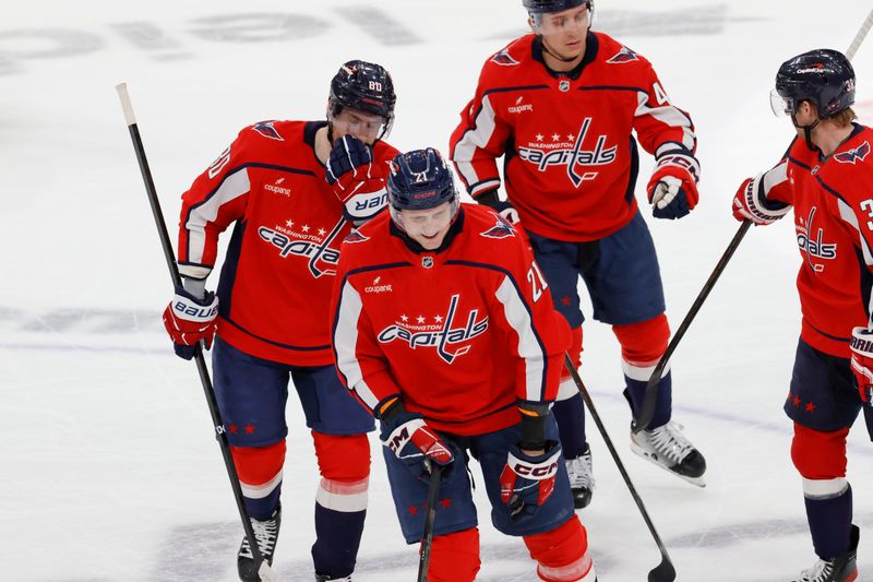 Mar 20, 2026; Washington, District of Columbia, USA; Washington Capitals left wing Aliaksei Protas (21) celebrates with teammates after scoring a goal against the New Jersey Devils during the third period at Capital One Arena. Mandatory Credit: Amber Searls-Imagn Images