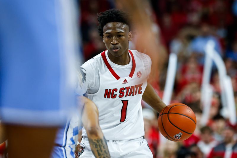 Feb 19, 2023; Raleigh, North Carolina, USA; North Carolina State Wolfpack guard Jarkel Joiner (1) dribbles during the first half of the game against North Carolina Tar Heels at PNC Arena. Mandatory Credit: Jaylynn Nash-USA TODAY Sports