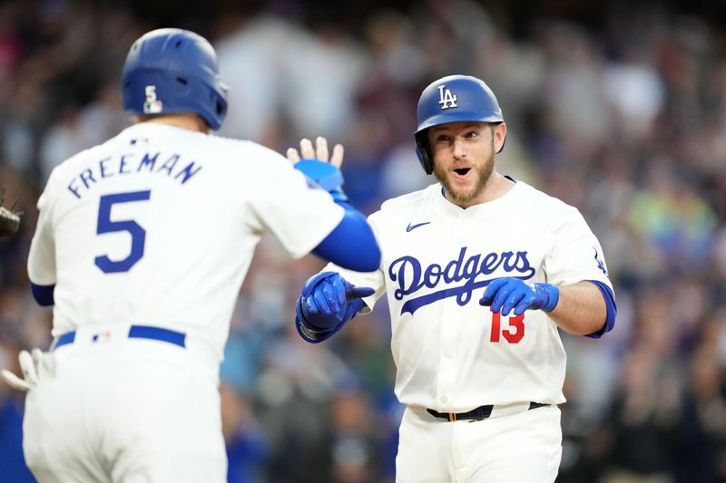 May 7, 2024; Los Angeles, California, USA; Los Angeles Dodgers third baseman Max Muncy (13) celebrates with catcher Austin Barnes (15) after hitting a grand slam in the first inning against the Miami Marlins at Dodger Stadium. Mandatory Credit: Kirby Lee-USA TODAY Sports