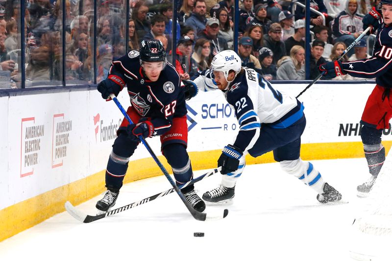 Nov 1, 2024; Columbus, Ohio, USA; Columbus Blue Jackets defenseman Jordan Harris (22) skates with the puck as Winnipeg Jets center Mason Appleton (22) trails the play during the first period at Nationwide Arena. Mandatory Credit: Russell LaBounty-Imagn Images