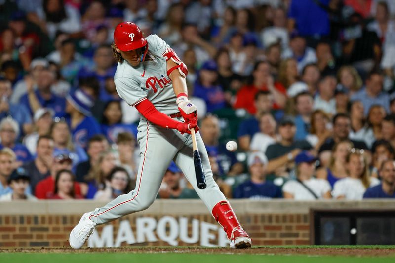 Jul 3, 2024; Chicago, Illinois, USA; Philadelphia Phillies third baseman Alec Bohm (28) hits a two-run home run against the Chicago Cubs during the sixth inning at Wrigley Field. Mandatory Credit: Kamil Krzaczynski-USA TODAY Sports