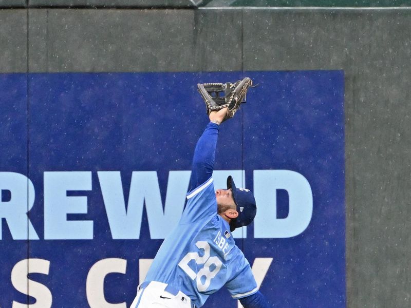 Apr 25, 2024; Kansas City, Missouri, USA;  Kansas City Royals center fielder Kyle Isbel (28) makes a leaping catch against Toronto Blue Jays George Springer (not pictured) in the fifth inning at Kauffman Stadium. Mandatory Credit: Peter Aiken-USA TODAY Sports