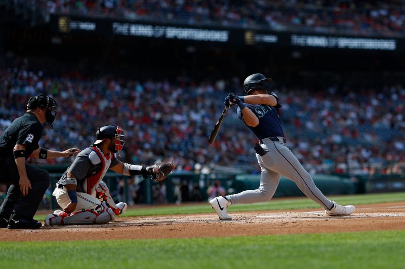 May 25, 2024; Washington, District of Columbia, USA; Seattle Mariners outfielder Dominic Canzone (8) singles against the Washington Nationals during the second inning at Nationals Park. Mandatory Credit: Geoff Burke-USA TODAY Sports