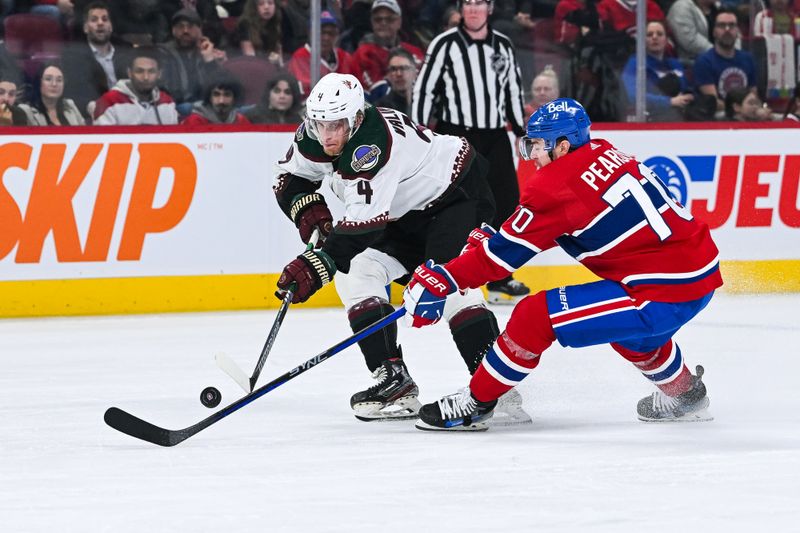 Feb 27, 2024; Montreal, Quebec, CAN; Montreal Canadiens left wing Tanner Pearson (70) defends the puck against Arizona Coyotes defenseman Juuso Valimaki (4) during the third period at Bell Centre. Mandatory Credit: David Kirouac-USA TODAY Sports