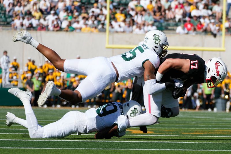 Nov 4, 2023; Waco, Texas, USA;  Houston Cougars tight end Mike O'Laughlin (17) makes a catch against Baylor Bears cornerback Caden Jenkins (19) and linebacker Garmon Randolph (55) during the first half at McLane Stadium. Mandatory Credit: Chris Jones-USA TODAY Sports