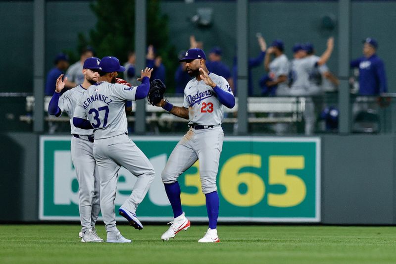 Jun 17, 2024; Denver, Colorado, USA; Los Angeles Dodgers left fielder Teoscar Hernandez (37) and center fielder Andy Pages (44) and right fielder Jason Heyward (23) celebrate after the game against the Colorado Rockies at Coors Field. Mandatory Credit: Isaiah J. Downing-USA TODAY Sports