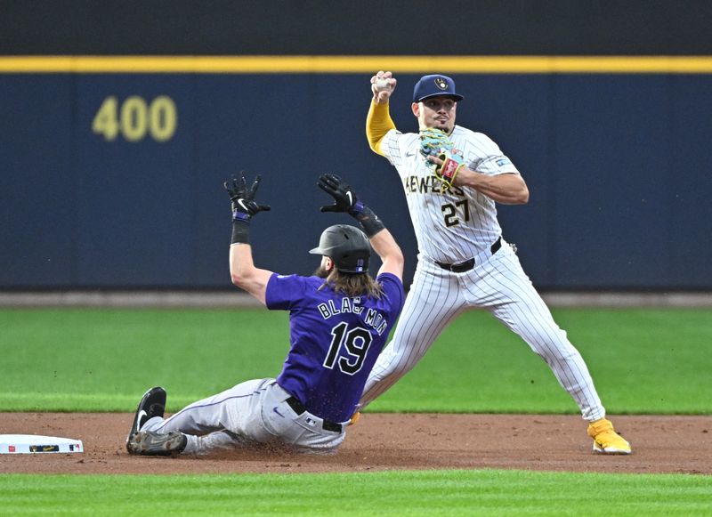 Sep 7, 2024; Milwaukee, Wisconsin, USA; Milwaukee Brewers shortstop Willy Adames (27) gets the force at second base against Colorado Rockies outfielder Charlie Blackmon (19) but can’t complete the double play in the first inning at American Family Field. Mandatory Credit: Michael McLoone-Imagn Images