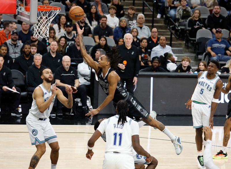 SAN ANTONIO, TX - JANUARY  27:  Devin Vassell #24 of the San Antonio Spurs drives over the Minnesota Timberwolves  in the first half at Frost Bank Center on January 27, 2024 in San Antonio, Texas. NOTE TO USER: User expressly acknowledges and agrees that, by downloading and or using this photograph, User is consenting to terms and conditions of the Getty Images License Agreement. (Photo by Ronald Cortes/Getty Images)
