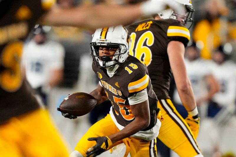 Oct 26, 2024; Laramie, Wyoming, USA; Wyoming Cowboys wide receiver Chris Durr Jr. (15) runs against the Utah State Aggies during the fourth quarter at Jonah Field at War Memorial Stadium. Mandatory Credit: Troy Babbitt-Imagn Images