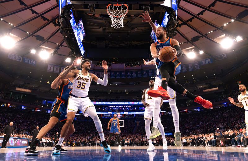 NEW YORK, NEW YORK - FEBRUARY 03:  Jalen Brunson #11 of the New York Knicks passes the ball against Christian Wood #35 of the Los Angeles Lakers during their game at Madison Square Garden on February 03, 2024 in New York City.   User expressly acknowledges and agrees that, by downloading and or using this photograph, User is consenting to the terms and conditions of the Getty Images License Agreement.  (Photo by Al Bello/Getty Images)