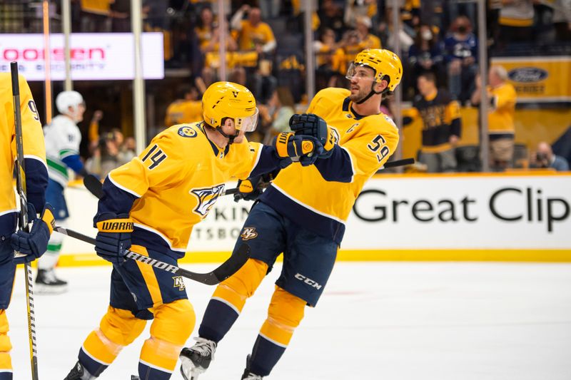 Apr 28, 2024; Nashville, Tennessee, USA; Nashville Predators defenseman Roman Josi (59) celebrates the goal of center Gustav Nyquist (14) against the Vancouver Canucks during the second period in game four of the first round of the 2024 Stanley Cup Playoffs at Bridgestone Arena. Mandatory Credit: Steve Roberts-USA TODAY Sports