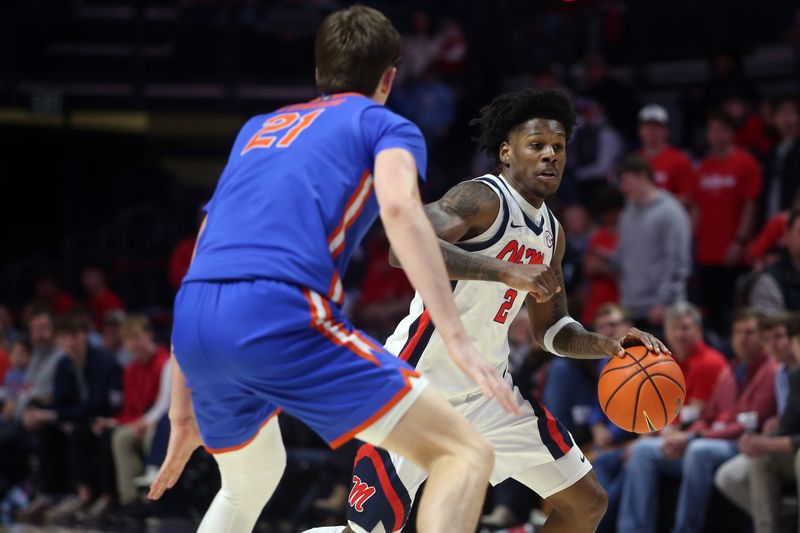 Feb 21, 2026; Oxford, Mississippi, USA; Mississippi Rebels guard AJ Storr (2) dribbles as Florida Gators forward/center Alex Condon (21) defends during the first half at The Sandy and John Black Pavilion at Ole Miss. Mandatory Credit: Petre Thomas-Imagn Images