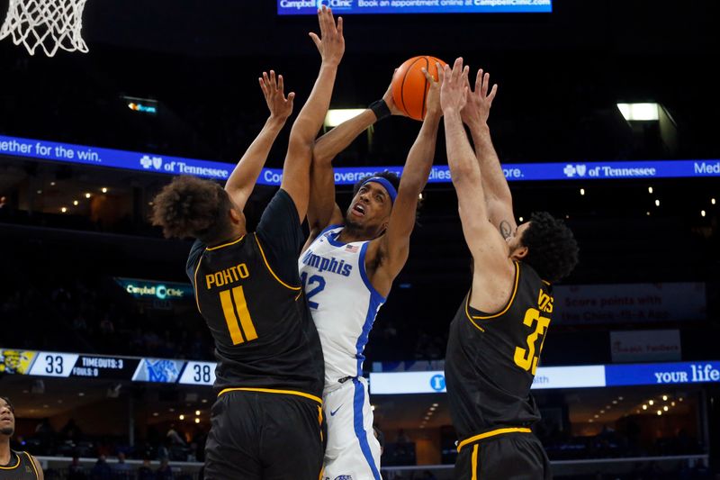 Jan 19, 2023; Memphis, Tennessee, USA; Memphis Tigers forward DeAndre Williams (12) drives to the basket between Wichita State Shockers forward Kenny Pohto (11) and forward James Rojas (33) during the second half at FedExForum. Mandatory Credit: Petre Thomas-USA TODAY Sports