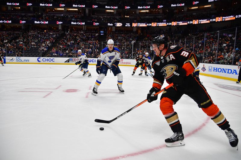 Apr 7, 2024; Anaheim, California, USA; Anaheim Ducks right wing Jakob Silfverberg (33) moves the puck against St. Louis Blues defenseman Colton Parayko (55) during the second period at Honda Center. Mandatory Credit: Gary A. Vasquez-USA TODAY Sports