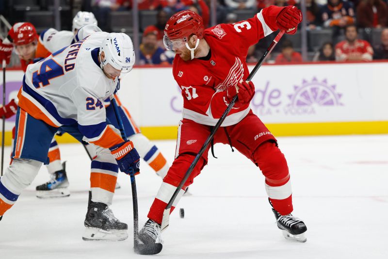 Nov 20, 2025; Detroit, Michigan, USA;  New York Islanders defenseman Scott Mayfield (24) and Detroit Red Wings left wing J.T. Compher (37) battle for the puck in the second period at Little Caesars Arena. Mandatory Credit: Rick Osentoski-Imagn Images